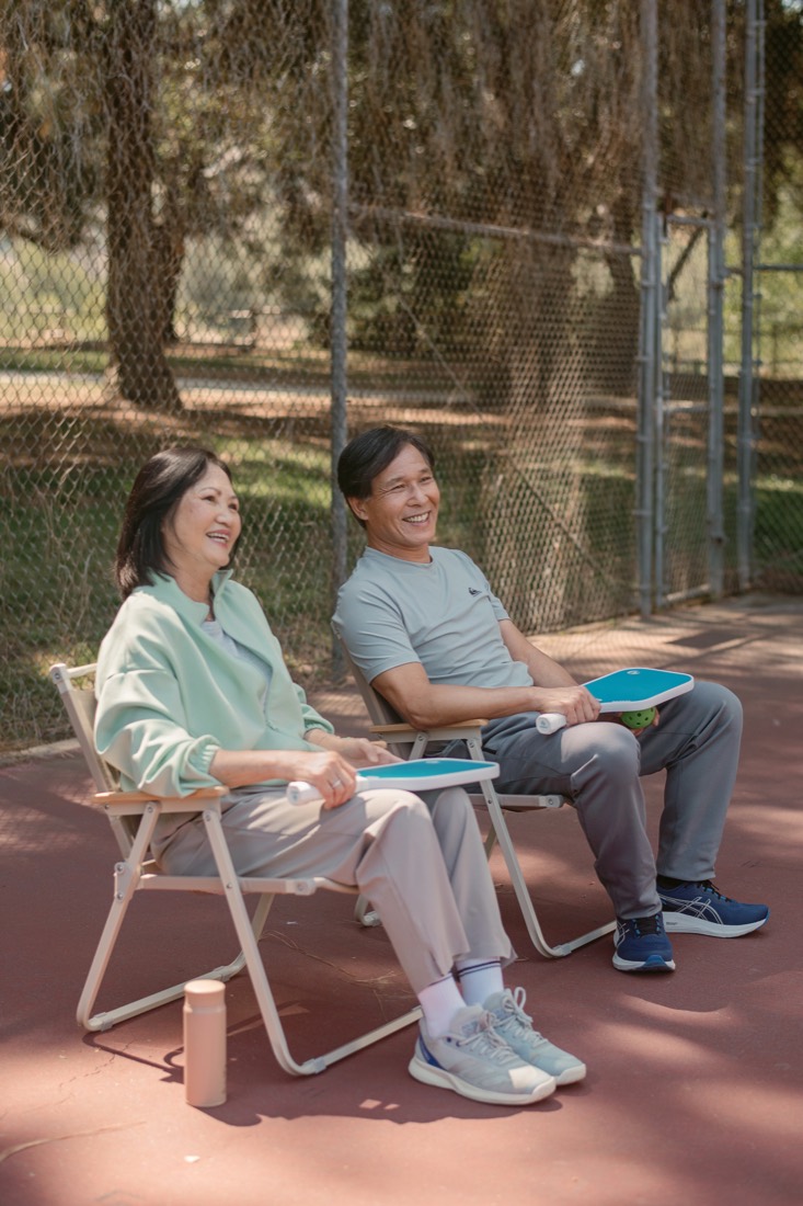 A couple relaxing in camping chairs at a Southern California park