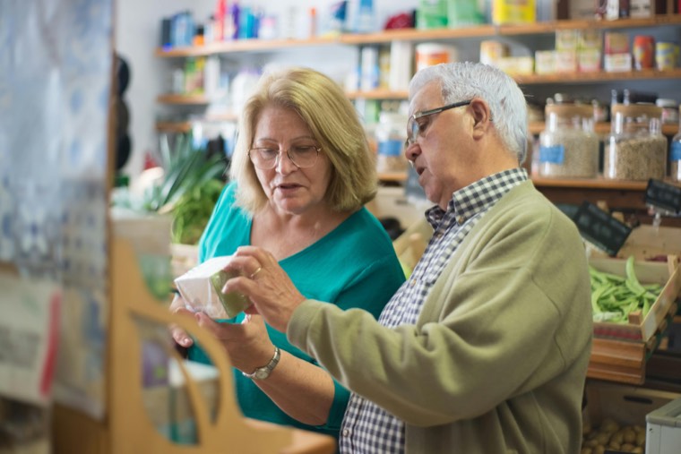 A couple choosing herbal remedies at an apothecary