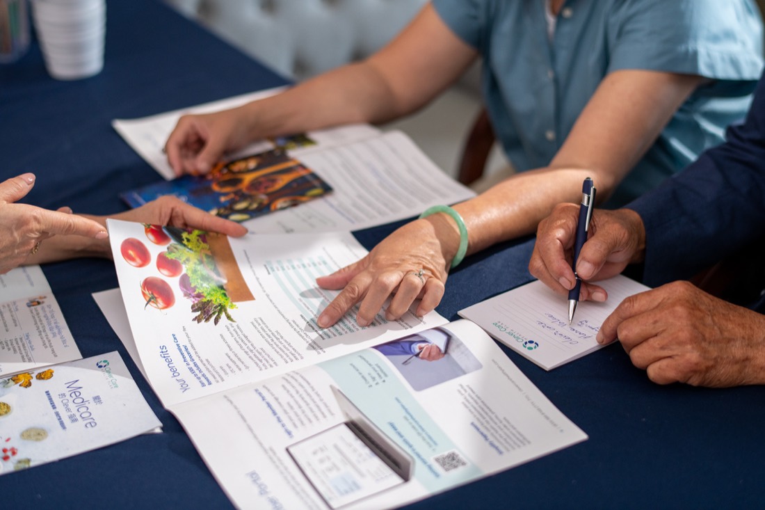 Two people reviewing Clever Care plan materials at a table