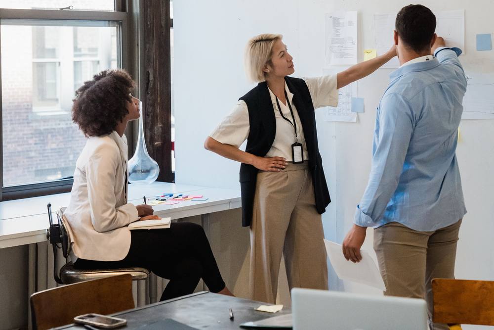 Team members in a workshop at a whiteboard