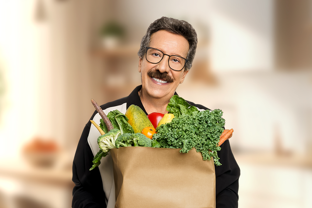 Humberto Luna holding a bag of groceries