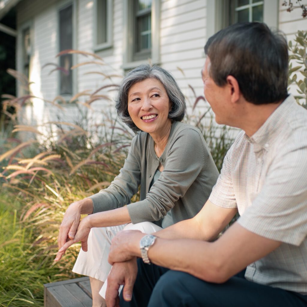 Two Clever Care members chatting together outdoors